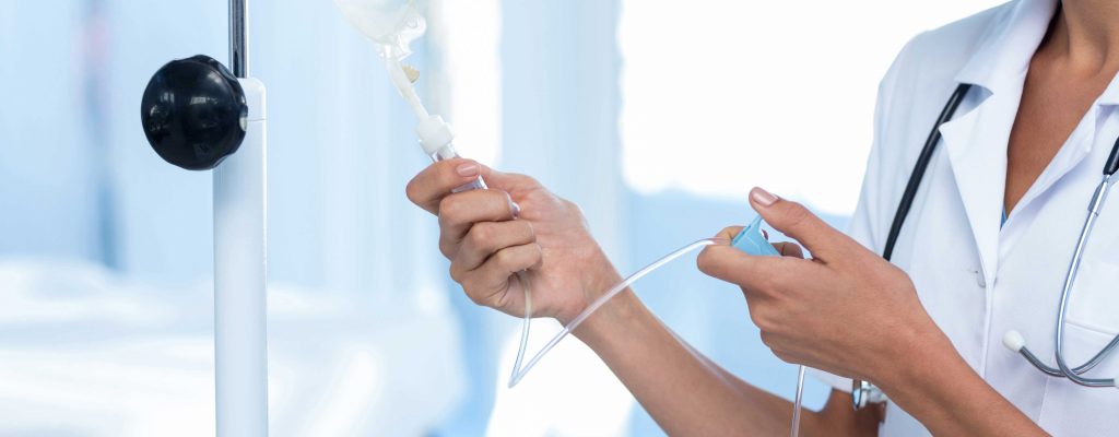 Nurse adjusting IV drip | EndoTool Glucose Management System